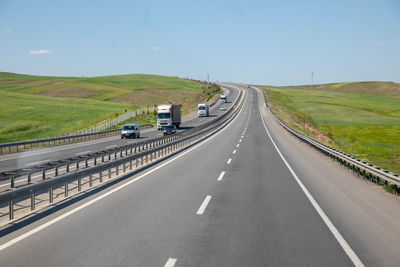 Road passing through landscape against sky