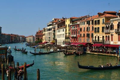 Boats in canal along buildings