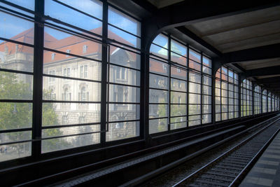 Railroad tracks against sky seen through window