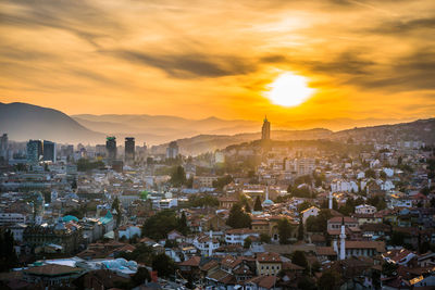 Aerial view of city at sunset