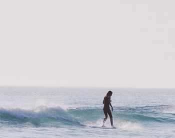 Full length of man on beach against clear sky