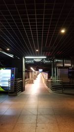 Illuminated railroad station platform at night