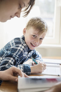 Portrait of boy sitting on table