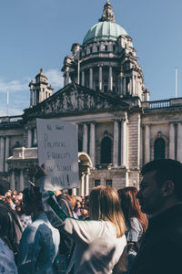 Rear view of people in front of building