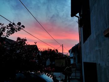 Low angle view of silhouette trees against sky