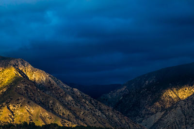 Scenic view of mountain against cloudy sky