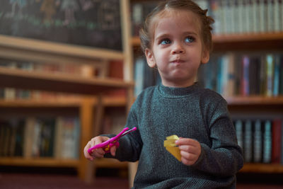 Cute girl making face sitting at home