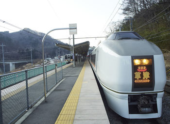 Train at railroad station against clear sky