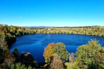 Scenic view of river against clear blue sky