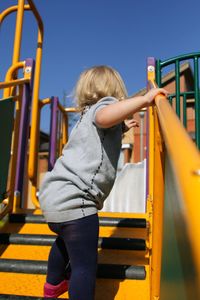 Rear view of girl playing in playground