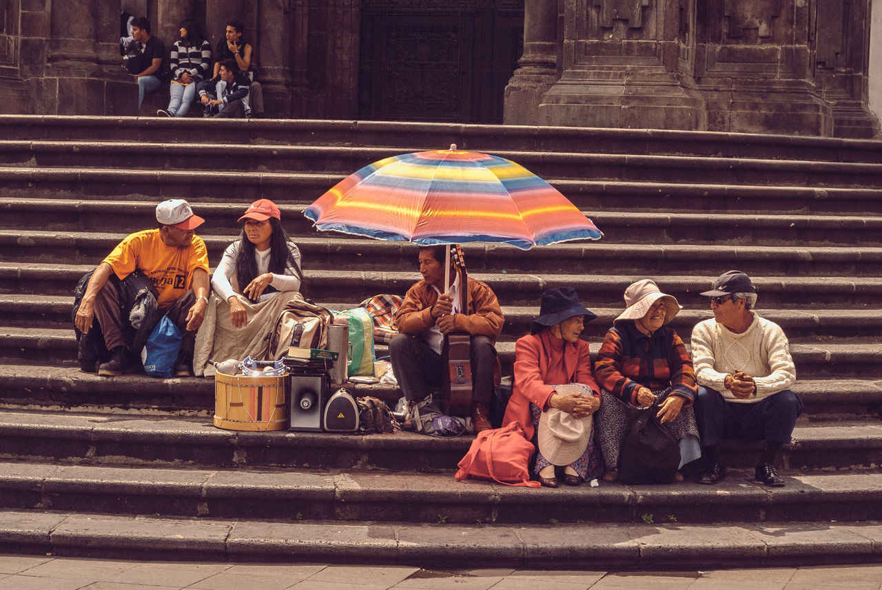 men, street, person, lifestyles, full length, walking, leisure activity, large group of people, multi colored, rear view, medium group of people, outdoors, cultures, casual clothing, group of people, road, traditional clothing, togetherness, incidental people