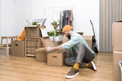 Adult man moving in new unfurnished apartments