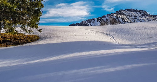 Scenic view of snowcapped mountains against sky