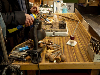 Midsection of man working at workshop