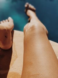 Low section of woman sitting on table