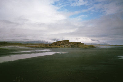 Scenic view of sea against cloudy sky