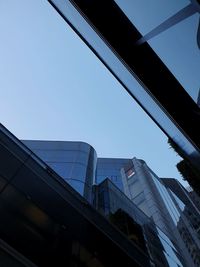 Low angle view of modern building against clear blue sky