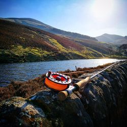 Boat moored on lake against sky