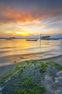 Scenic view of beach against sky during sunset