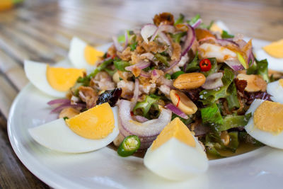 Close-up of salad with boiled eggs served in plate on table