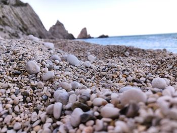 Rocks on beach against sky