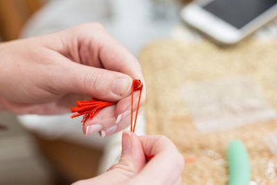 Close-up of hand holding red finger