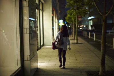 Woman on window shopping alone on street