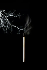 Close-up of cigarette against black background