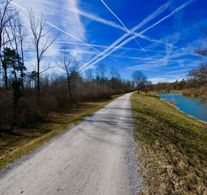 Road amidst trees against sky