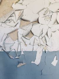 High angle view of broken paper on wall