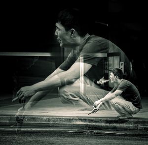 Side view of young couple sitting at night