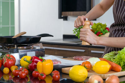 Woman preparing fruits in kitchen at home