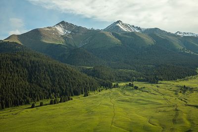 Scenic view of landscape and mountains against sky