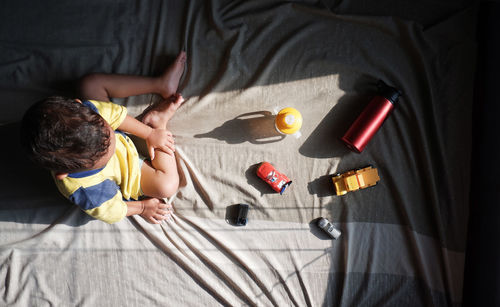 High angle view of people relaxing on bed at home