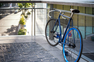 Bicycle parked against building in city