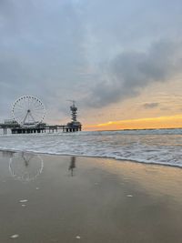 Ferris wheel at beach during sunset