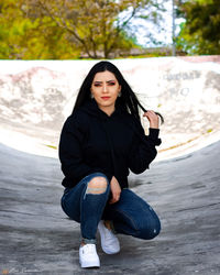 Portrait of beautiful young woman sitting outdoors