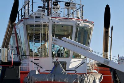 Low angle view of ship moored at harbor against sky