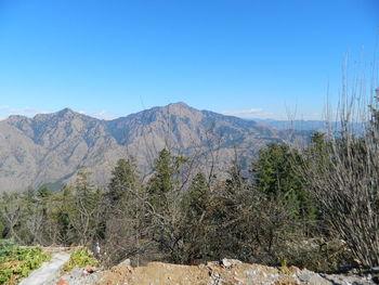 Scenic view of mountains against clear blue sky