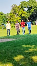 People on field against trees
