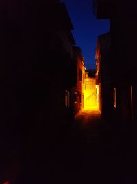 Illuminated building against sky at night