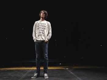 Man standing on stage against sky at night