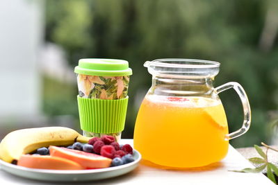 Close-up of juice in glass jar on table