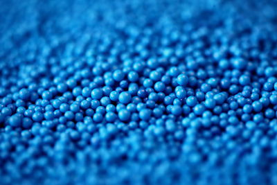 Full frame shot of blue sugar nonpareils sprinkles
