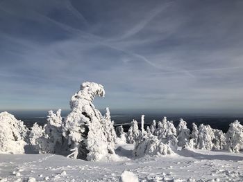 Snow covered landscape against sky