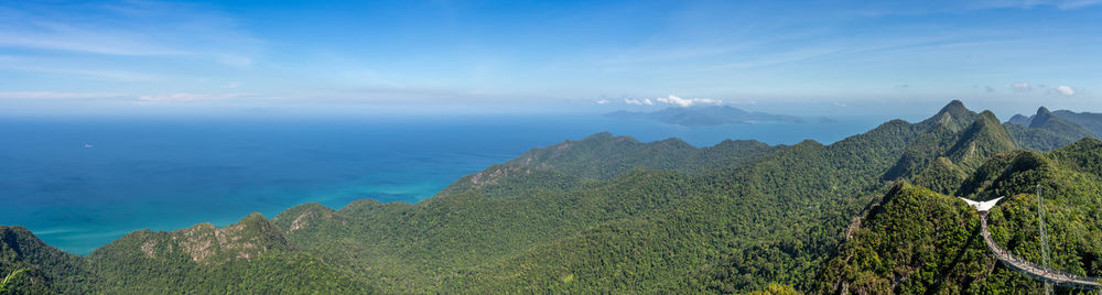 Scenic view of mountains against blue sky