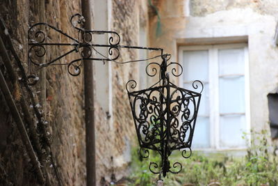 Close-up of abandoned lamp by building