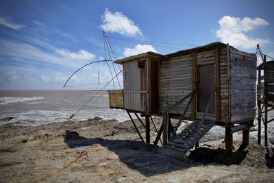 Built structure on beach against sky