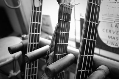 Close-up of guitars by window at home