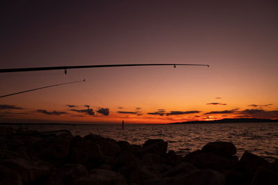 Scenic view of sea against romantic sky at sunset